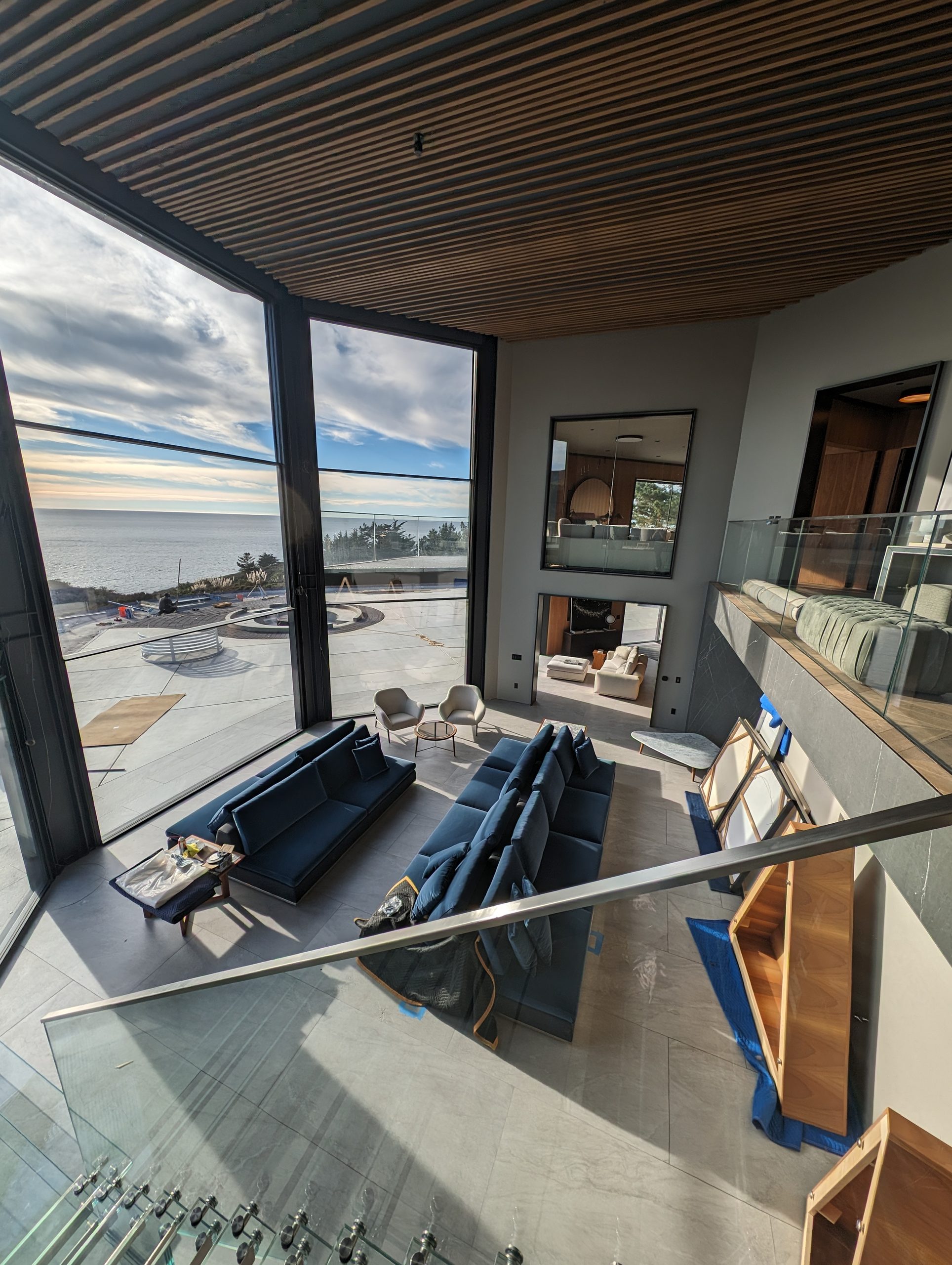 Double-height living volume looking out to the ocean terrace