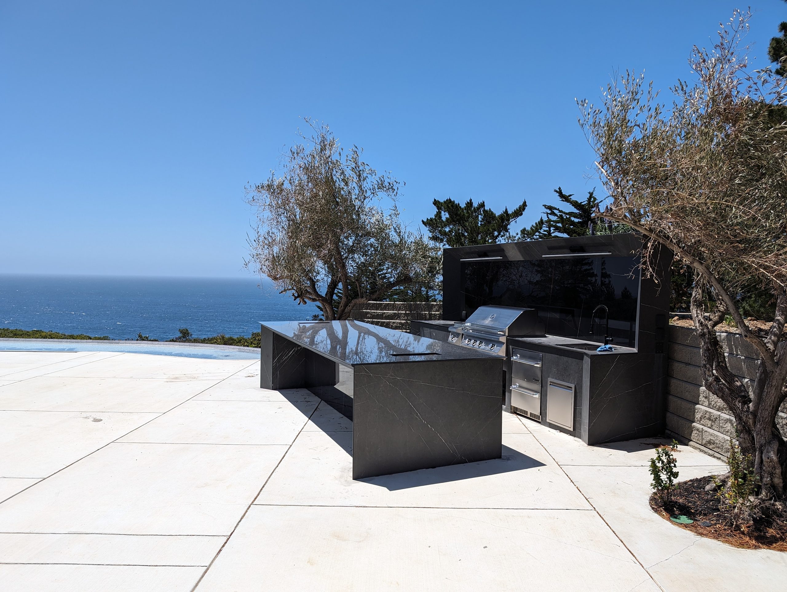 Outdoor kitchen on the terrace beside the infinity pool, ocean beyond