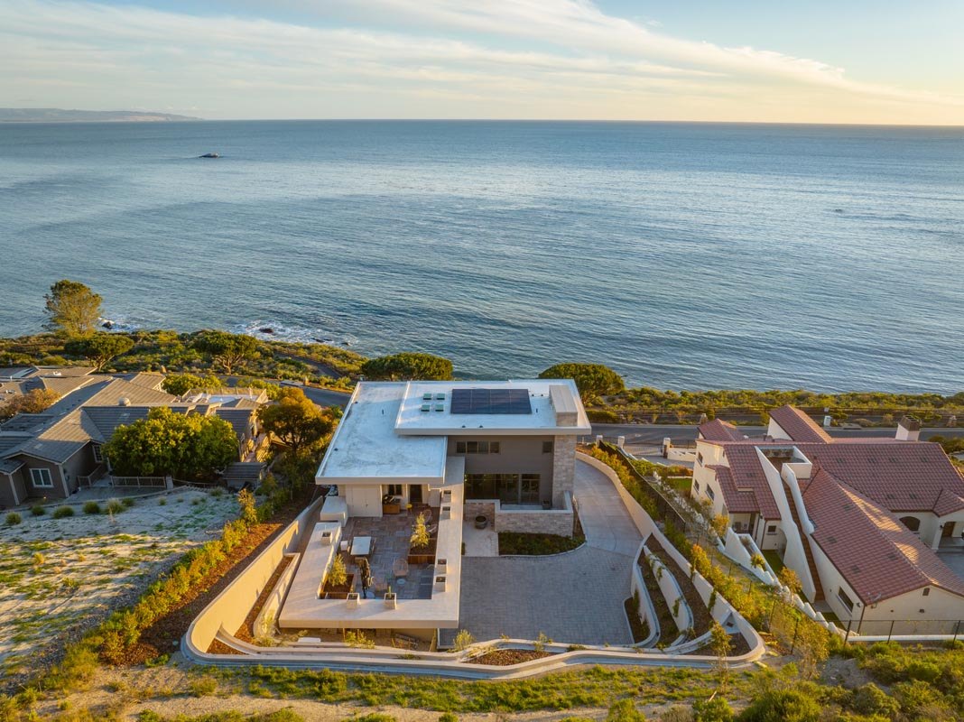 Aerial view over the roof terrace and the Pismo Beach coastline at dusk