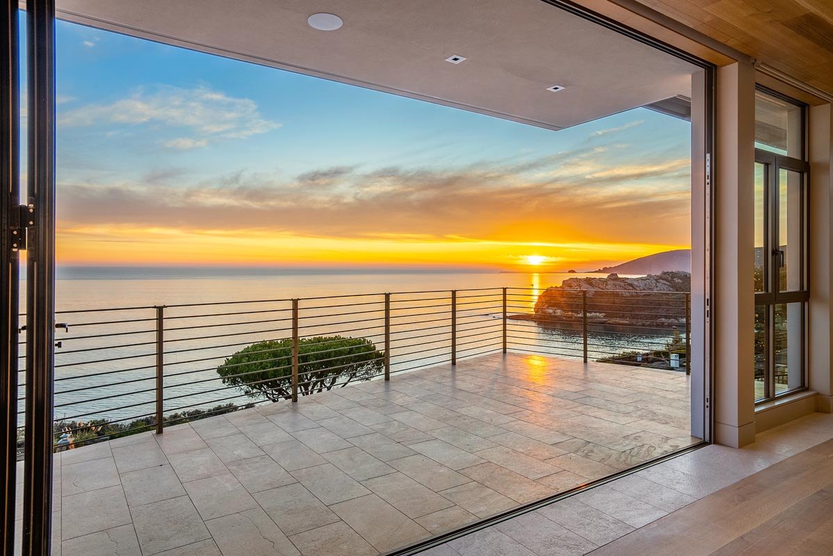 Corner of the living level pocketed fully open to the sunset over the cove