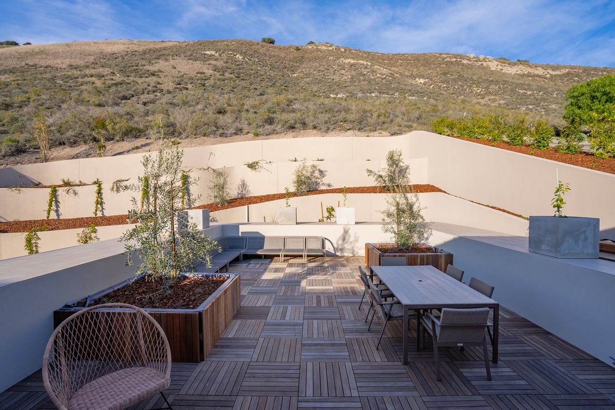 Roof terrace with outdoor lounge, hillside behind
