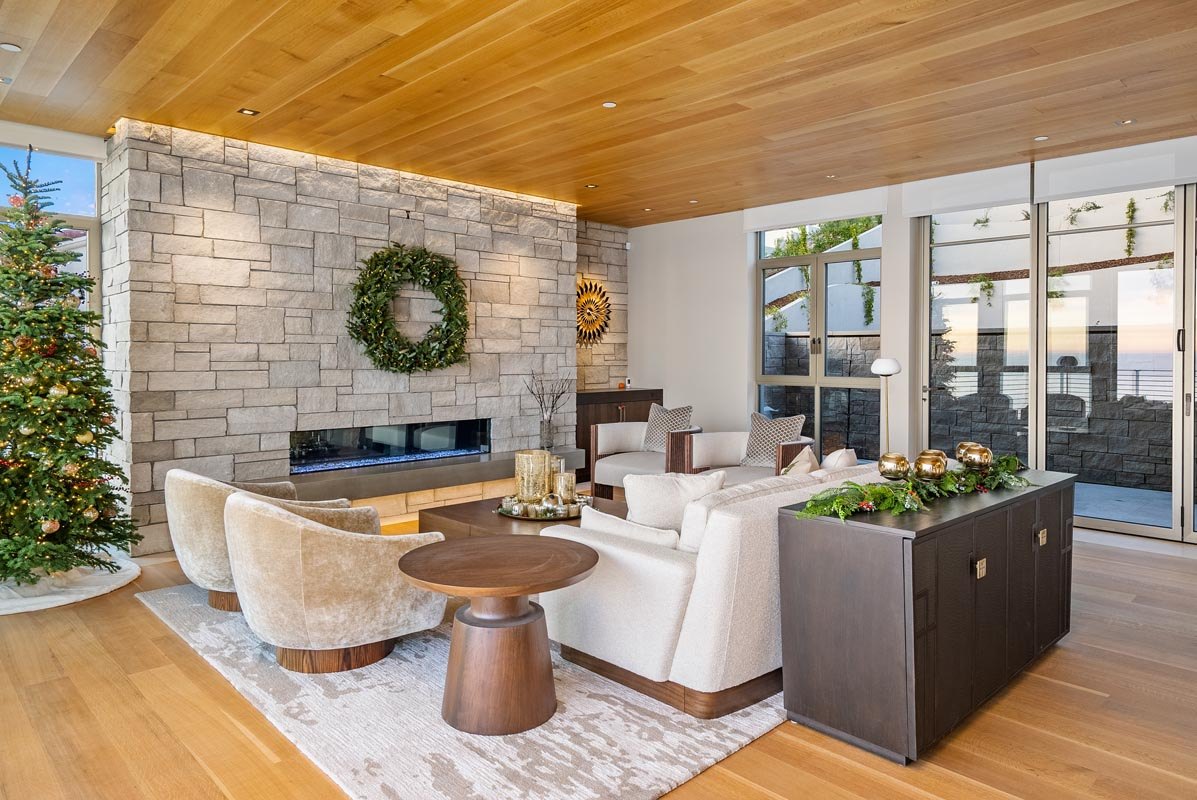 Lounge against the full-height stone fireplace wall