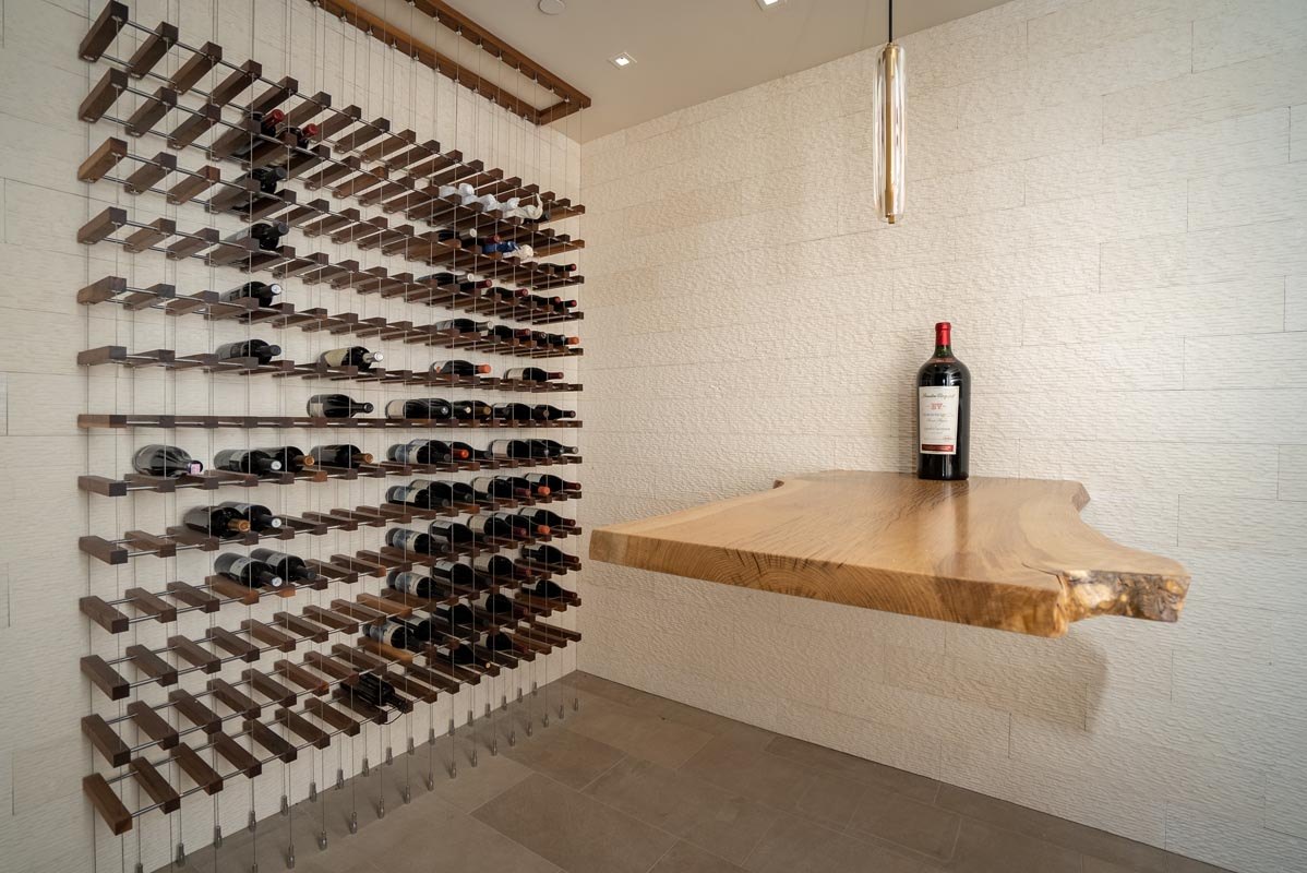 Wine wall on steel pin racks with a live-edge tasting shelf