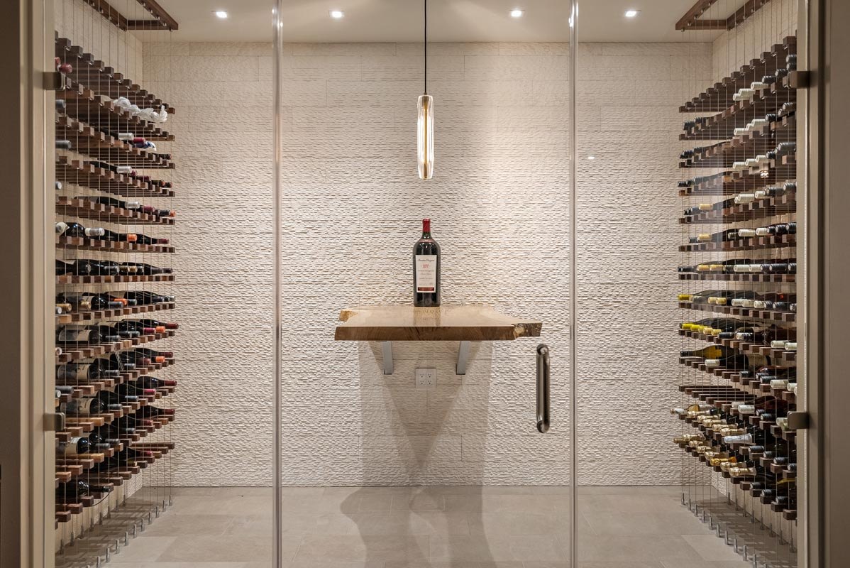The glass-walled wine cellar off the lower hall