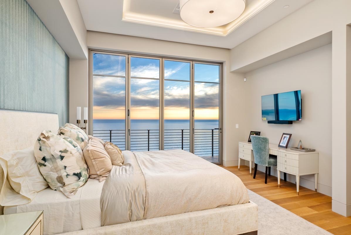 Bedroom with the glass corner pocketed open to the ocean
