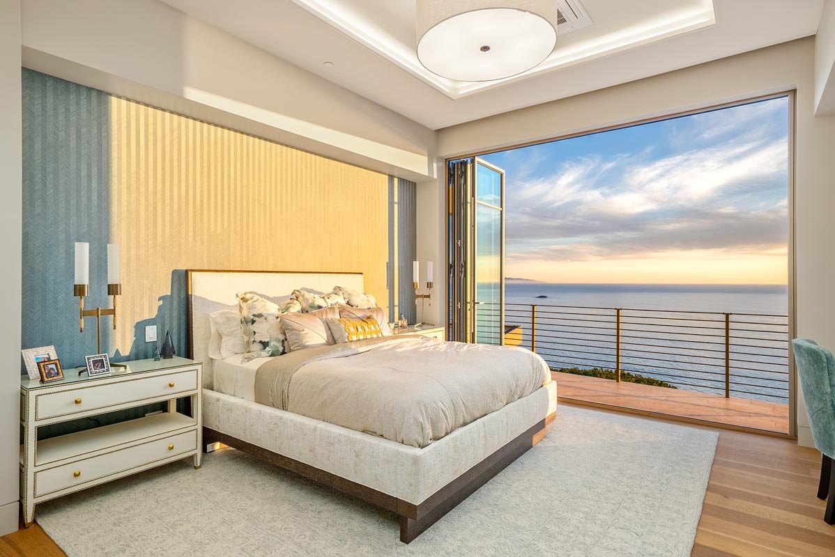 Guest bedroom opening to the terrace rail above the water
